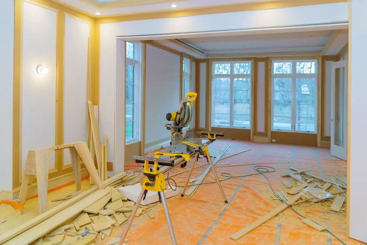 House mid-renovation with materials staged out front